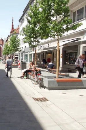 Paved surface in a pedestrian zone with integrated tree islands.