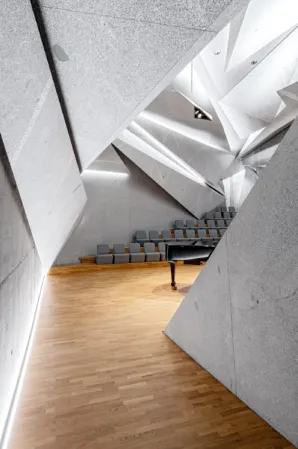 view into a concert hall clad with light granite