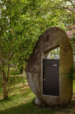 large boulder with cut-out opening for mailbox