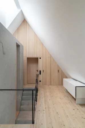 modern attic with view of a solid granite wall and staircase