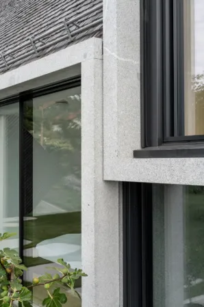 detail of a residential building with modern granite cubes as a central element