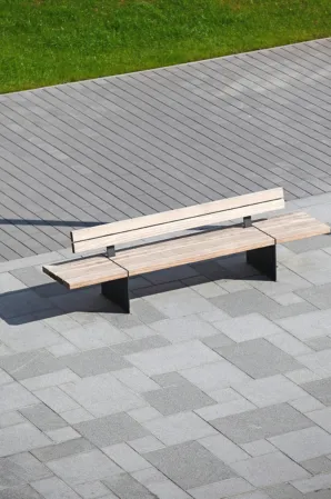 bench on a marketplace paved with two-tone granite