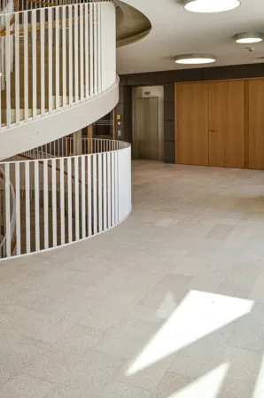 reddish-yellow flooring with view of staircase
