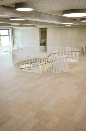 reddish-yellow flooring with view of staircase