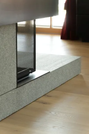 Detail shot of the cladding of a fireplace made from light-colored granite