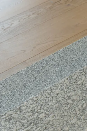 Detail shot of a flooring made out of wood and granite steps