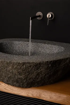 Basin made out of a dark boulder