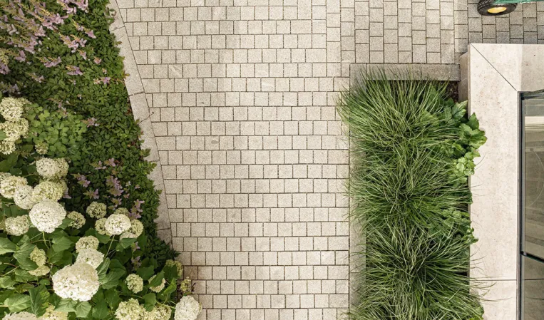 paving from a bird’s-eye view with adjacent flower bed