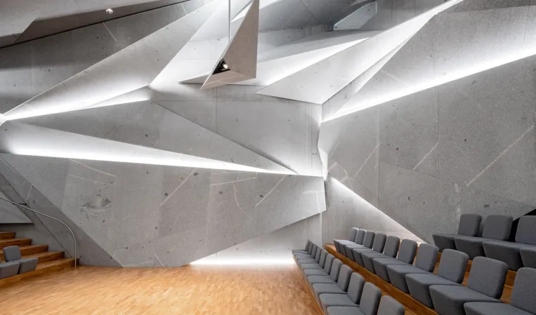 concert hall with splinter-shaped granite elements on wall and ceiling