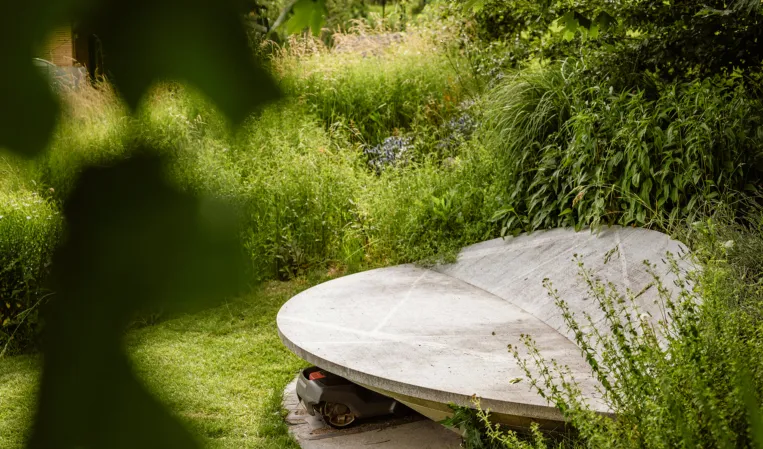 solid granite shelter for a robotic lawn mower