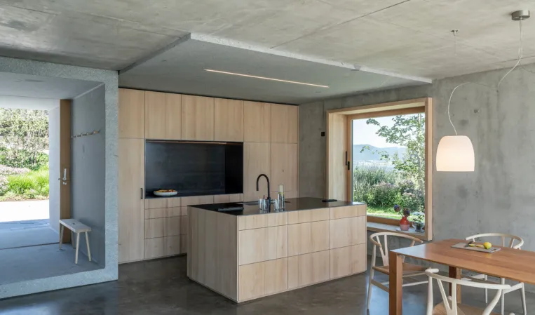 modern kitchen with view of entrance portal made of solid granite
