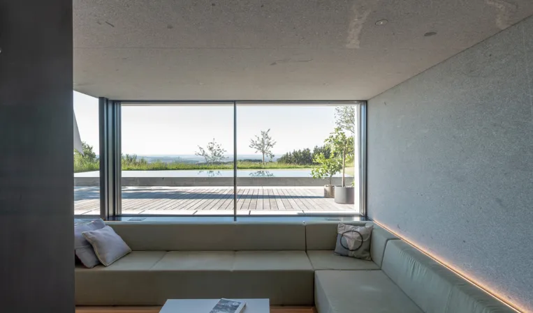 modern living room with concrete look and solid granite as ceiling element