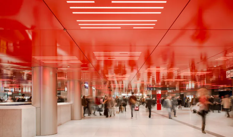 light granite flooring in a subway station with red ceiling elements