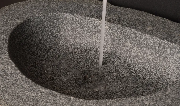Detail shot of a basin made out of a boulder