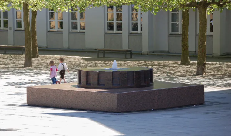 Eine drehende Scheibe einer Brunnenanlage die aussieht wie ein Zahnrad
