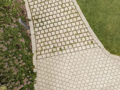 a paving meets a pavement sourrounded by greenery