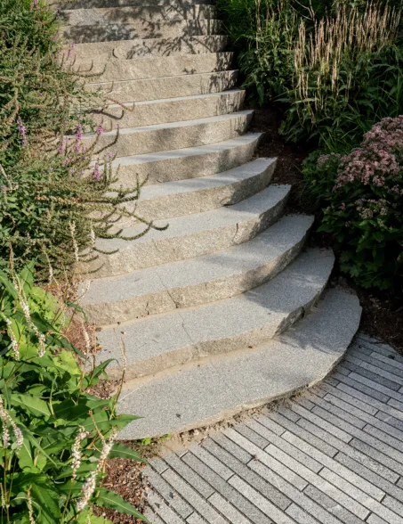 slab from a sliced boulder forming steps in a garden