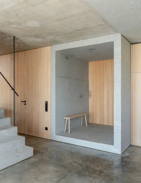an entrance portal made out of solid granite into a modern architectural house