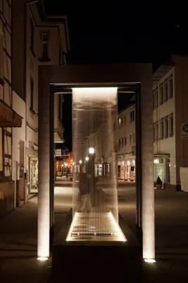 Brunneanlage mit Regenvorhang bei Nacht