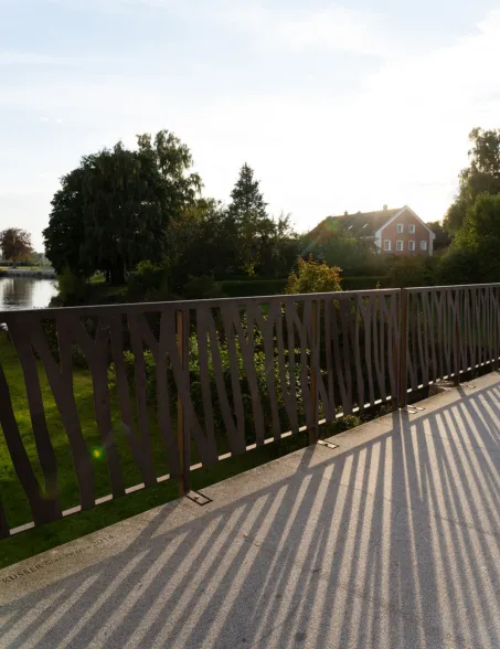 Bridge railing at sunset