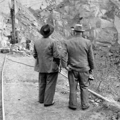 Historic image of two business men in a quarry